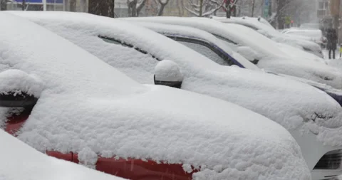A row of car stuck under the snow. Snow falling over the city car. Stock Footage 146858387
