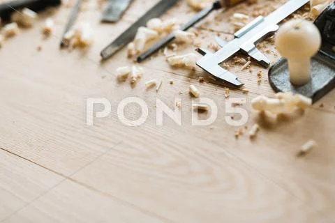 Row of carpentry tools and sawdust on wooden background Stock Photos
