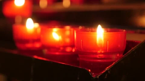 Row of Catholic prayer red cup votive candles in candle rack  slow motion 108 動画素材 67883346