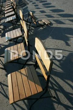 Row of chairs in a sunny day Stock Photos