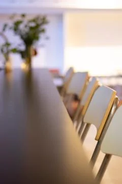 Row of chairs at table Stock Photos
