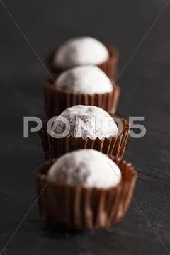 A row of champagne truffle pralines Stock Photos