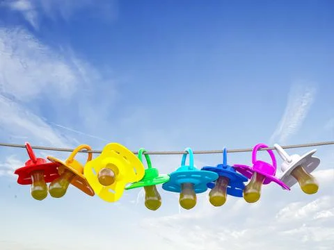 Row of child pacifier, soother and baby dummies on rope. 스톡 일러스트