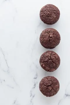 The row of chocolate muffins on a white table Stock Photos