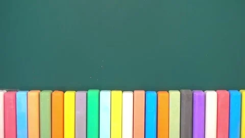 Row of colored chalks on green blackboard, concept of advert in education o.. Stock Footage 328576017