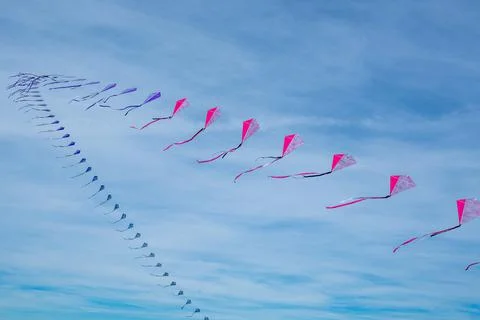 A row of colored kites in the sky Stock-Fotos