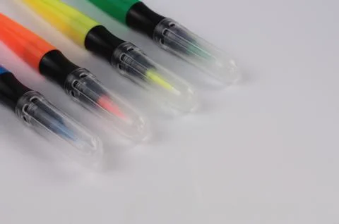 Row of colored marker brushes with transparent plastic tip Stock Photos
