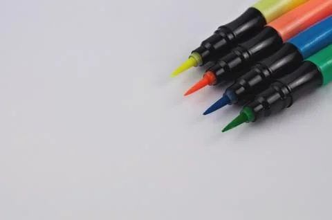 Row of colored markers brushes on white background with copy space Foto stock