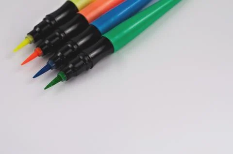 Row of colored markers brushes on white background with copy space Stock Photos