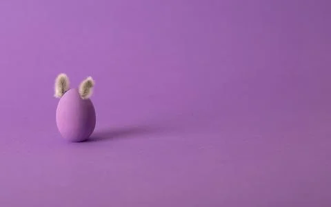 Row of colorful Easter eggs with willow bud ears painted in simple colors on  Stock Photos