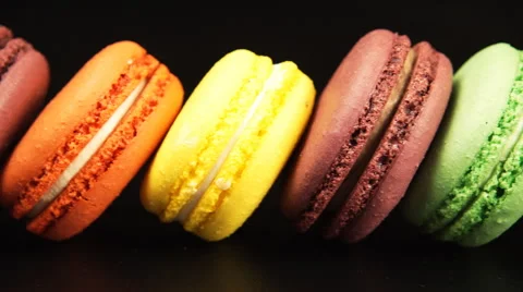 Row of a colorful macaroons is on the black background Stock Footage 53315718