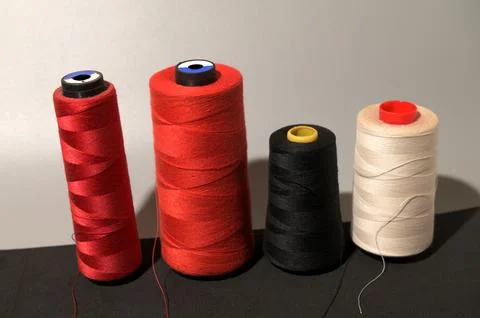 A row of colorful spools of thread Foto stock
