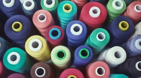 Row of colorful thread spools on table. Bright colors Video stock 68946009