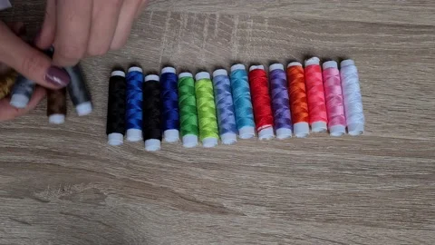 Row of colorful thread spools on table 動画素材 152410668