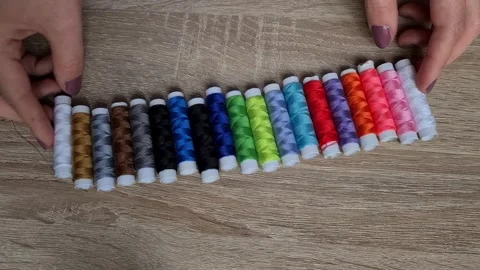 Row of colorful thread spools on table Stock Footage 152410691