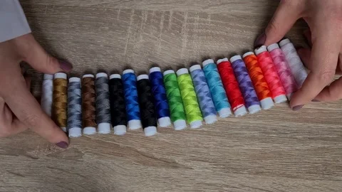 Row of colorful thread spools on table Stock-Footage 152410698