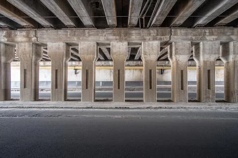 A row of columns inside an old empty car tunnel. Stock Photos