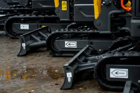 Row of compact excavators with rubber crawler tracks Stock Photos