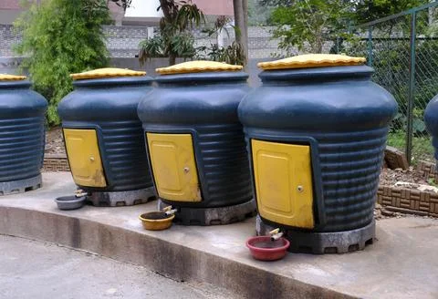 Row of composter bins used for curing wet waste and to collect liquid leach.. Stock Photos