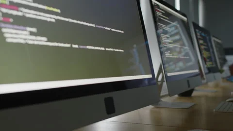 Row of Computer Screens with Code in Empty Classroom Stock Footage 278124477