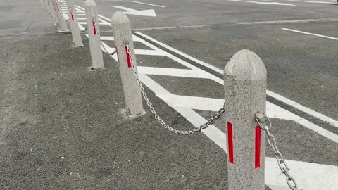 Row of Concrete Bollards with Chains and Restricted Zone Road Markings Stock Footage 343475554