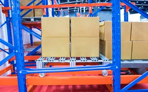 Row of cotton boxes kept in warehouse shelves ; Stock Photos