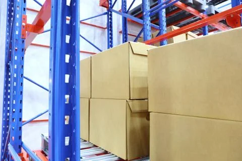 Row of cotton boxes kept in warehouse shelves ; Stock Photos