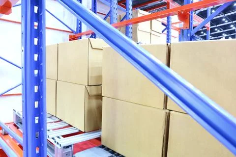 Row of cotton boxes kept in warehouse shelves ; Stock Photos