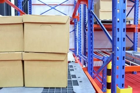 Row of cotton boxes kept in warehouse shelves ; Stock Photos