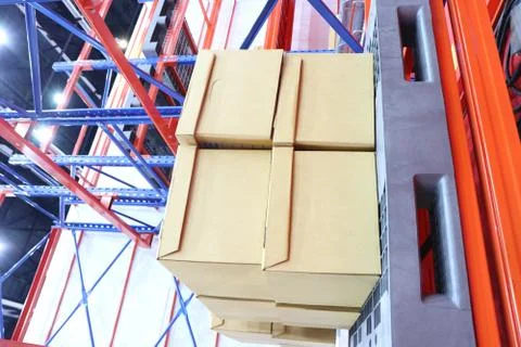 Row of cotton boxes kept in warehouse shelves ; Stock Photos