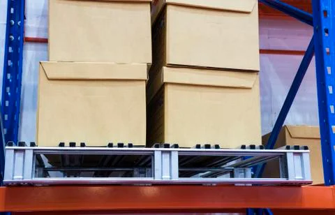 Row of cotton boxes kept in warehouse shelves ; Stock Photos