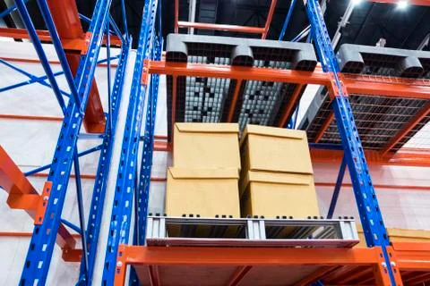 Row of cotton boxes kept in warehouse shelves ; Stock Photos