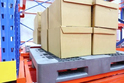 Row of cotton boxes kept in warehouse shelves ; Stock Photos