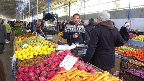 Row of counters at the farmer market and its sellers Stock Footage 73221349
