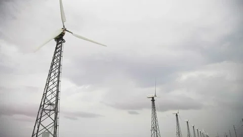 Row of up-to-date wind generators, cloudy grey sky, rainy weather Video stock 97101194