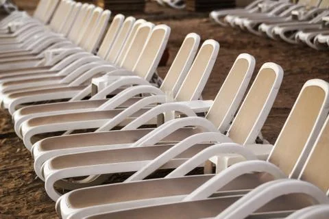 Row of deck chairs on beach close up Stock Photos