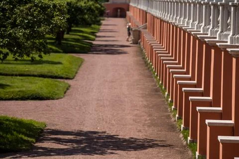 A row of decorative columns lines a path in a park Stock Photos