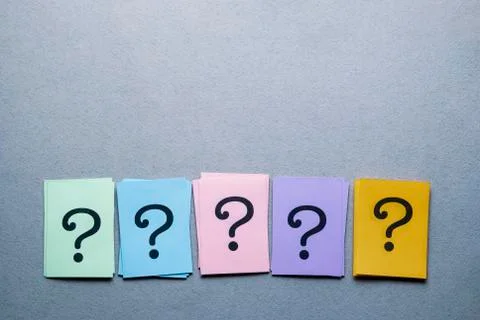Row of different colored cards with question marks Stock Photos