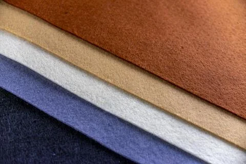 A row of different colored fabrics, including blue, white, and brown Foto stock