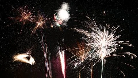 Row of different fireworks in front of starry sky 写真素材