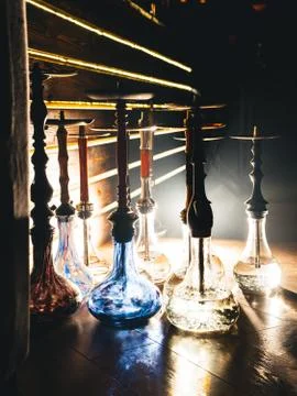 Row of different hookahs in a staff-room in a dramatic light Stock Photos