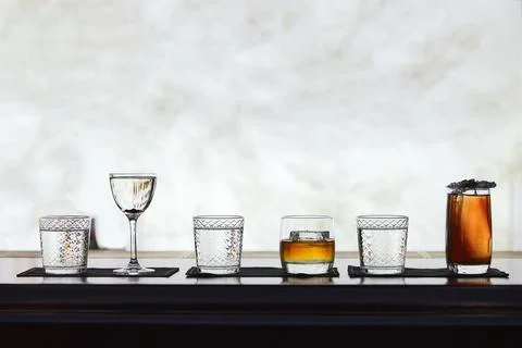 Row of different simple cocktail drinks, darker themes Stock Photos