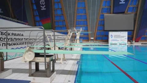 Row of diving platforms rises above calm pool water Stock Footage 317145947