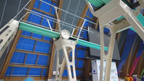 Row of diving platforms rises above calm pool water Stock Footage 317146176