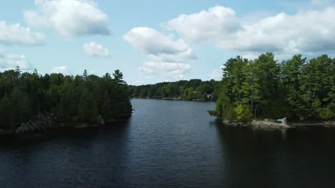 A row of docks sits opposite a channel on a lake Stock Footage 163332616
