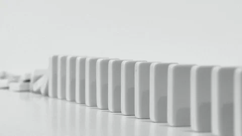 Row of Dominoes Falling in Slow Motion in Black and White in Reverse Stock Footage 83696367