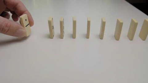 Row of dominoes falling in slow motion Stock Footage 130858824