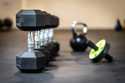 Row of dumbbell exercise weights on the floor Stock Photos