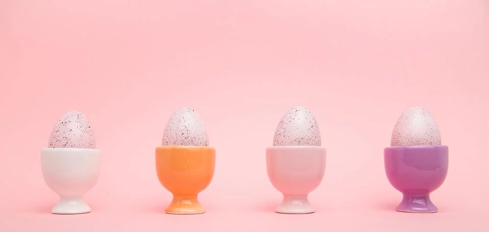 Row of eggs in cups Stock Photos