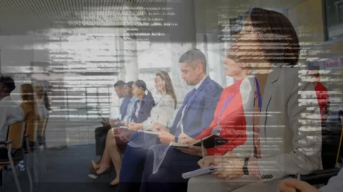 Row of eight professionals taking notes in Hall 10 business seminar while code Stock Footage 312240619